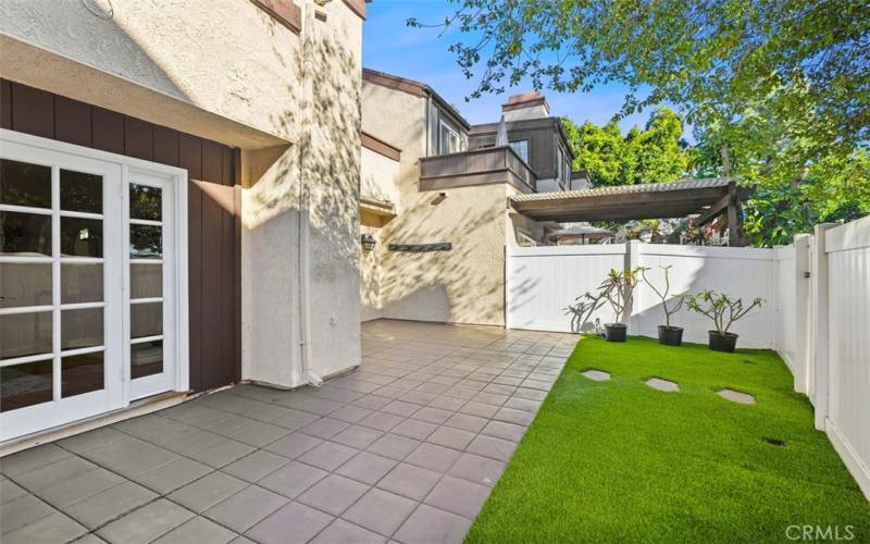 Private backyard with artificial turf.