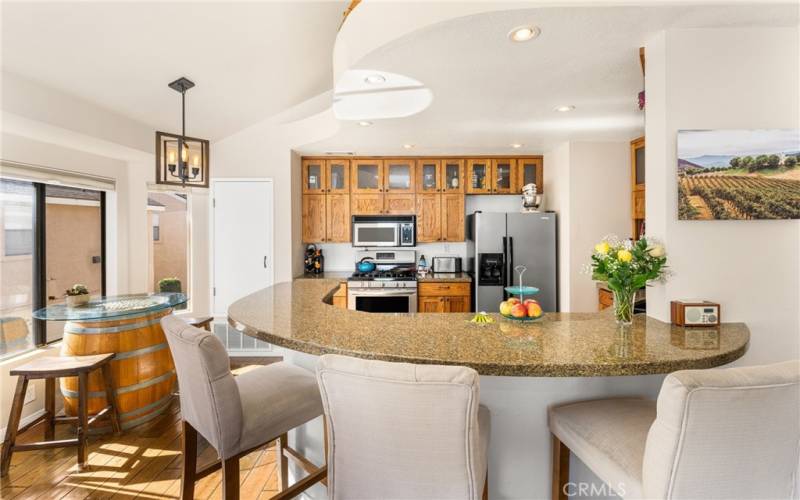 Light and bright kitchen and dining area with lots of cabinets.