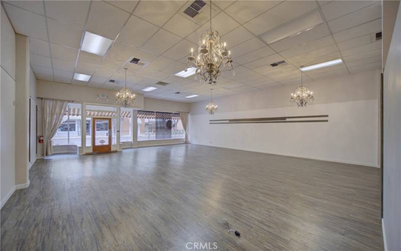 Interior of lease space with art hanging rails and stunning chandeliers