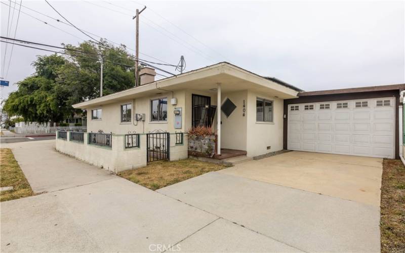 Corner home with carport and detached garage in the back