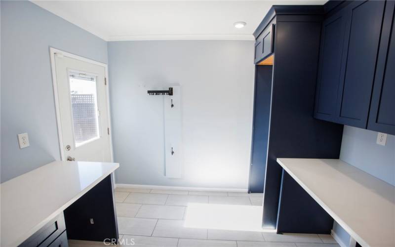 Laundry with door to backyard, wine fridge cubby