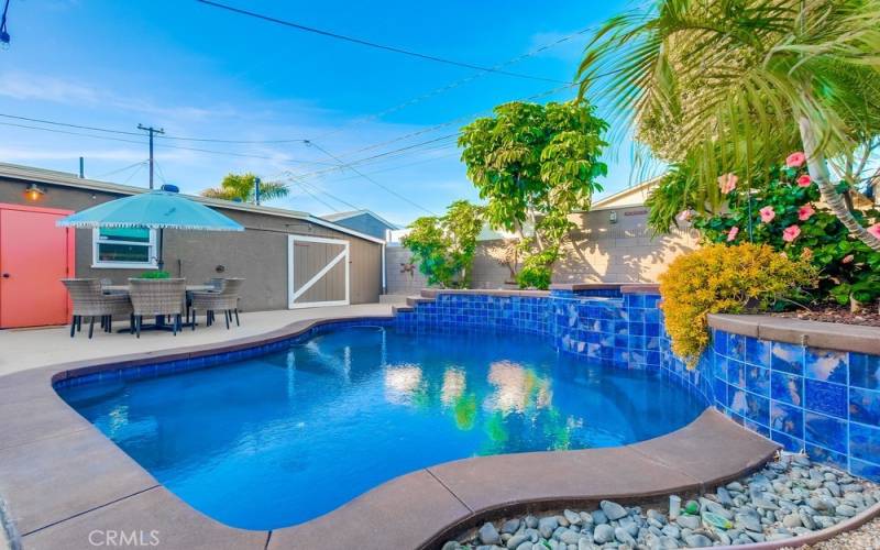 Sparkling pool with baja shelf and umbrella