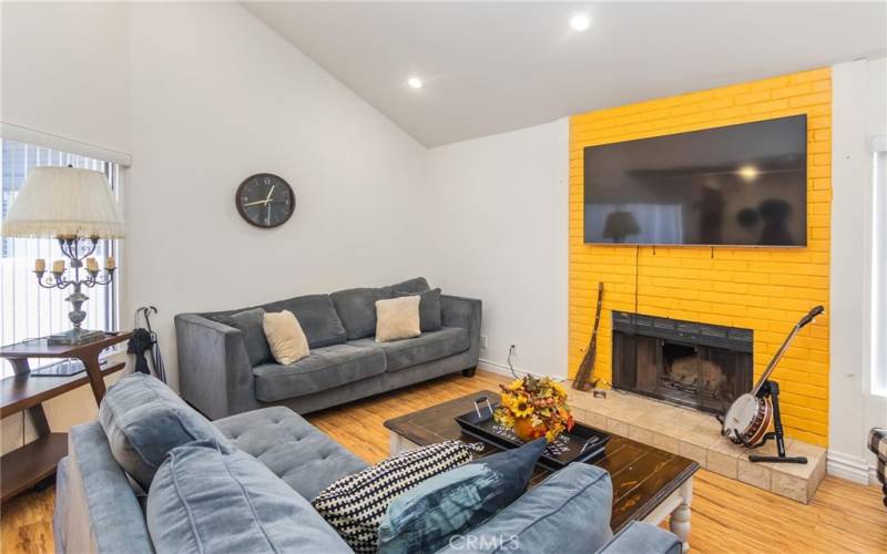 Step down living room with fireplace & high ceilings