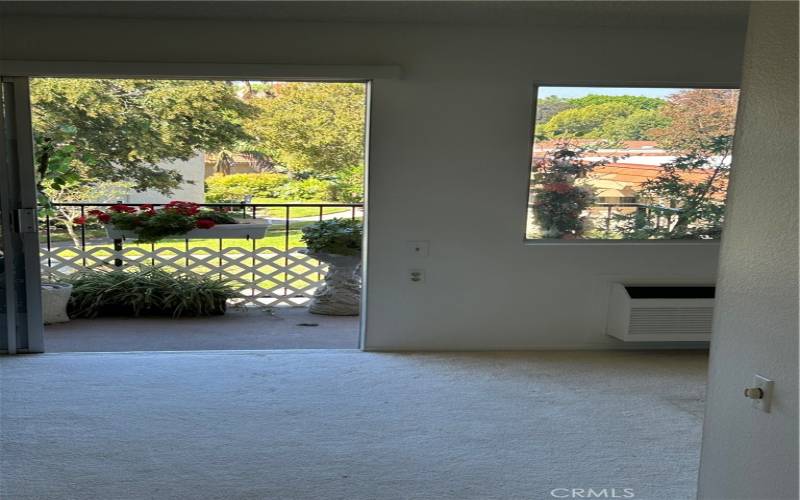 View from the hallway to the balcony, left is the family room with cozy fireplace, to the right dining area and the kitchen.