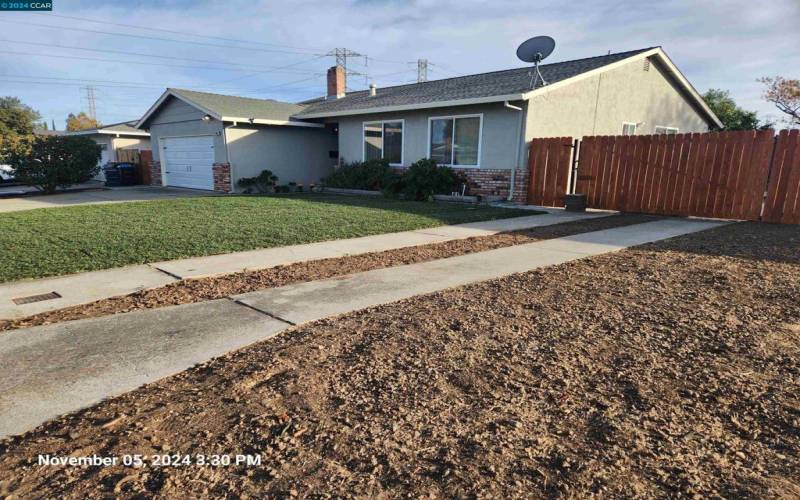 Ribbon Driveway leads to swing gate leads to over sized side yard