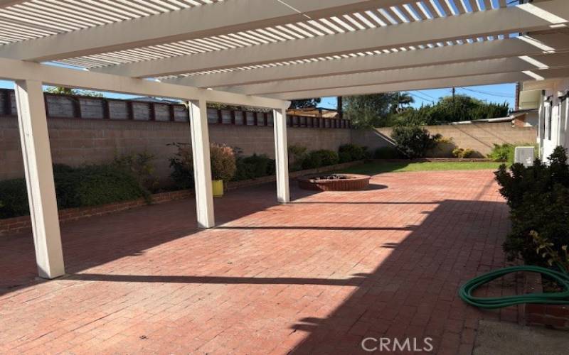 Beautiful big brick patio with shade cover and fire pit.