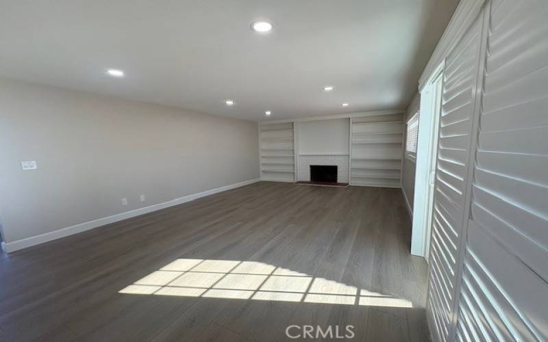 Another view of the living room. Note the new recessed lighting, on dimmers, plus extensive bookshelves.