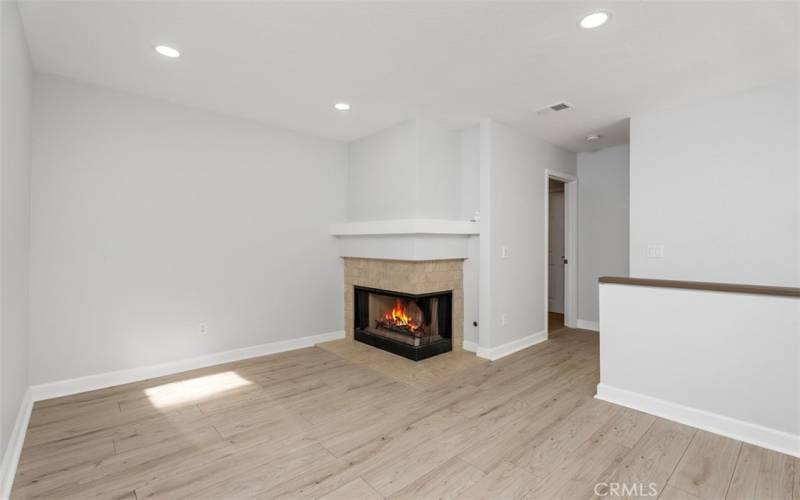 Large loft with skylight and gas fireplace.