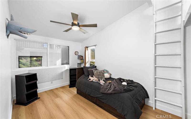 Third bedroom with vaulted ceiling and ladder to loft area