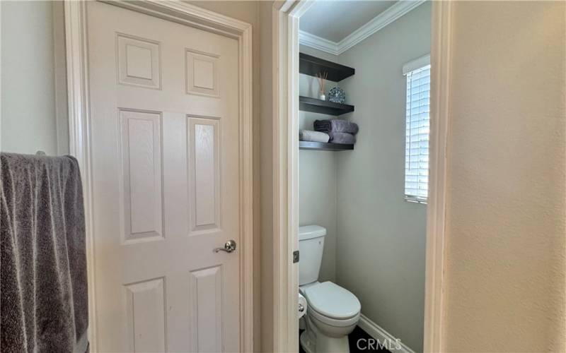 Primary bathroom door opens to a walk-in closet