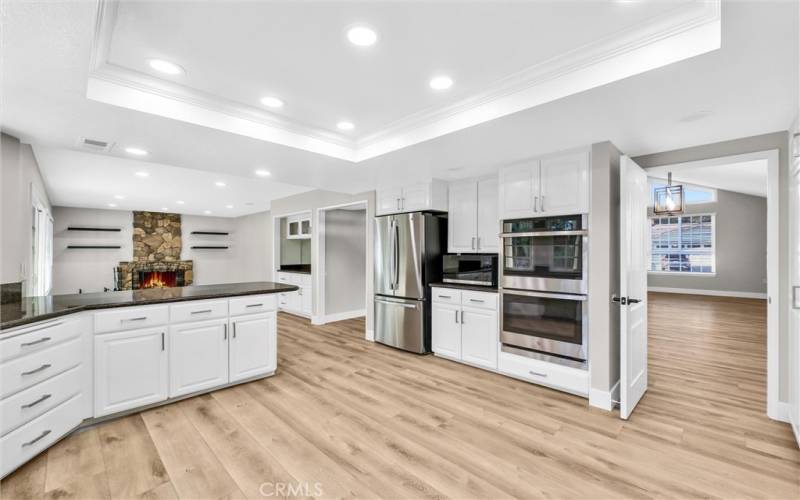 A view from the kitchen into the family room and into the dining room