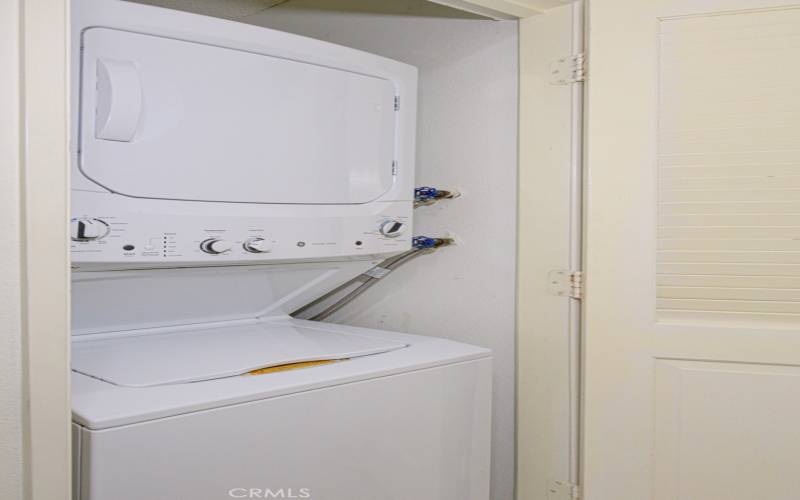 The stacked washer and dryer is included.  It's conveniently located in the hall.