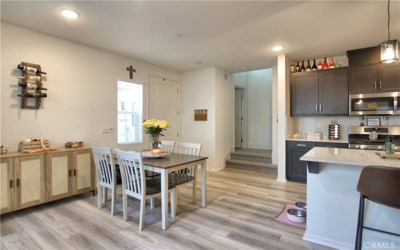 Dining area leading towards stairs.