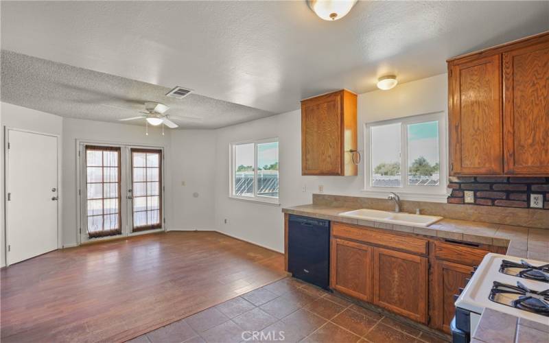 Large kitchen with dining area with doors leading to yard