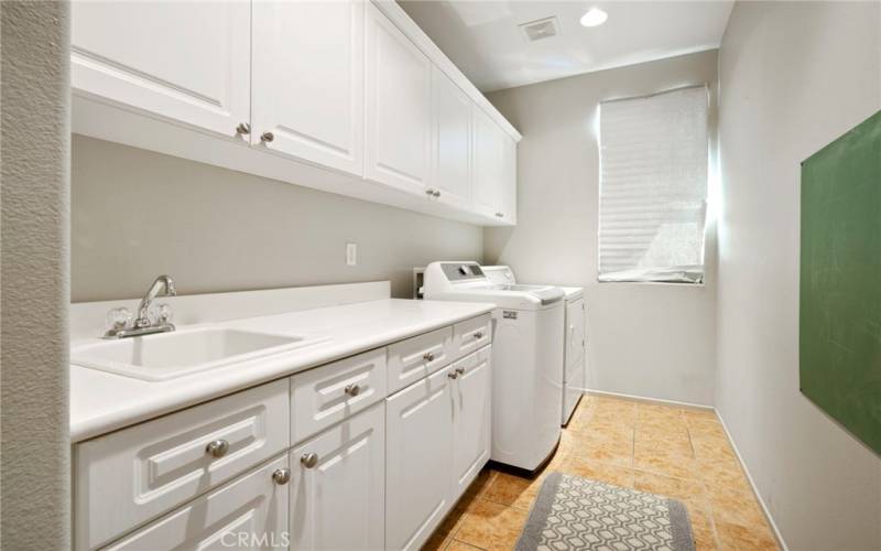 Laundry room with plenty of storage, sink and washer/dryer included!