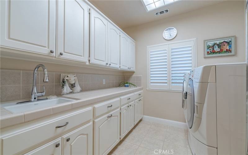 Laundry Room with lots of cabinets and a deep sink.