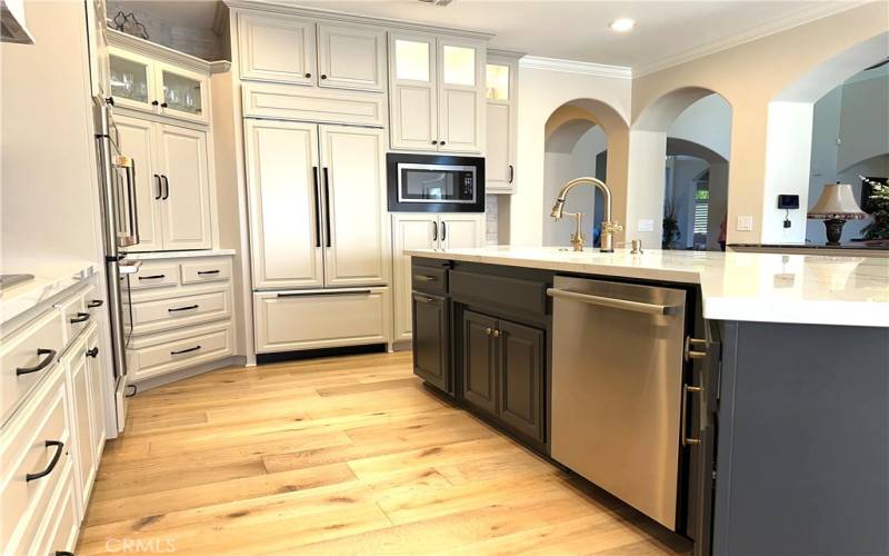 Large island with lots of room for extra seating accented by beautiful quartz counters and top of the line kitchen faucet.