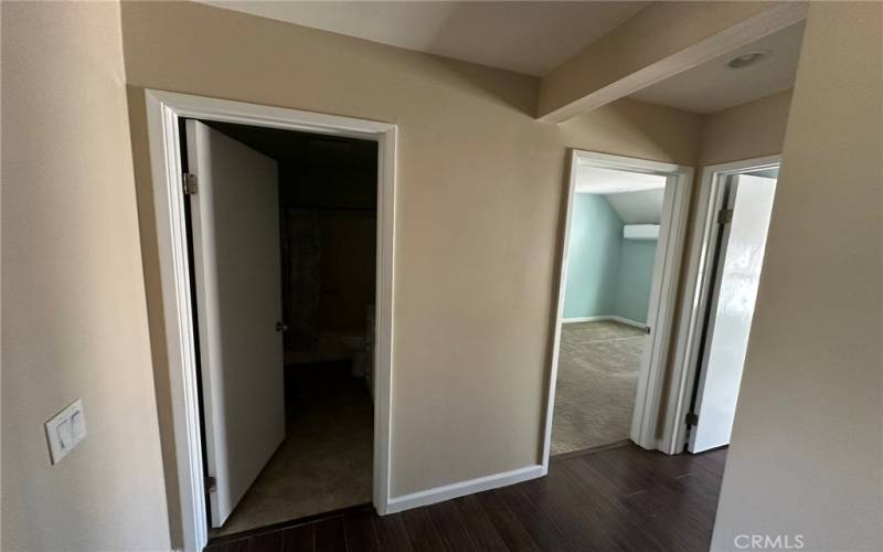 Full Bathroom door on left and bedroom 2 and 3 to the right