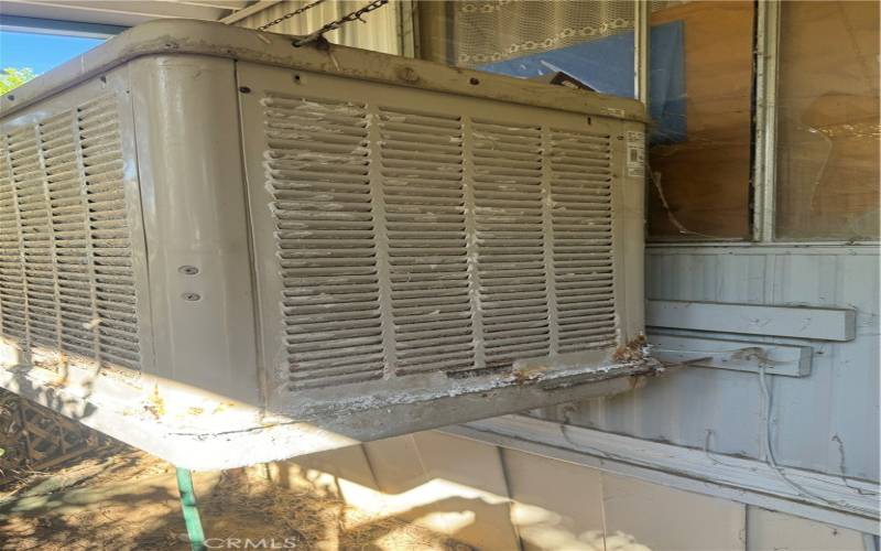 right side evaporative cooler front of home