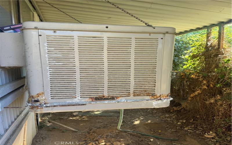 Left side evaporative cooler front of home