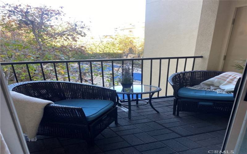 Very peaceful balcony looking over the playground area. Storage cabinet to the right.