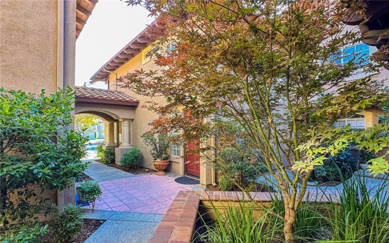 The home you've been searching for awaits, through this picturesque courtyard.