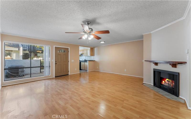 Living room has large window with blinds.