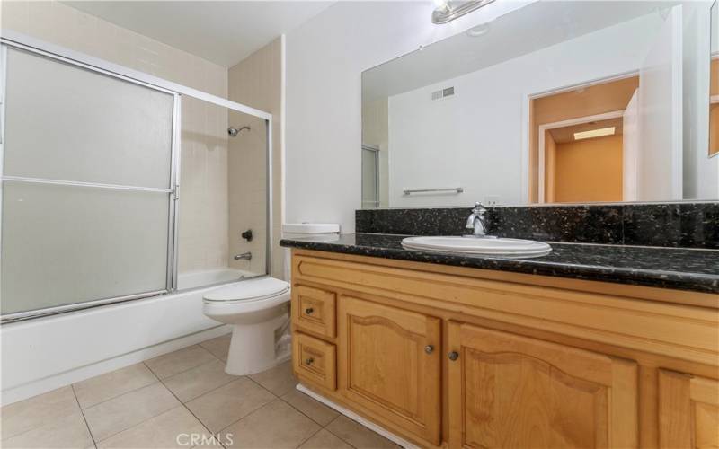 Upstairs common bath with granite tops and bathtub