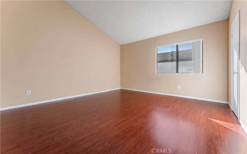 Second bedroom with large window and wooden floor. Newly pained.