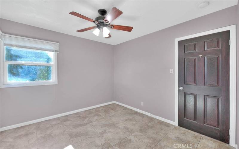 Ceiling fan and paneled door to the bedroom