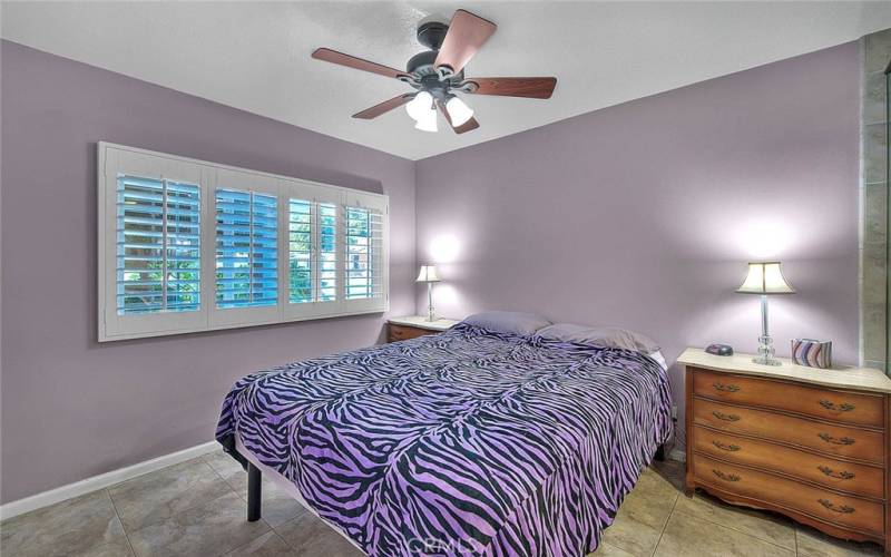 Primary bedroom with a celing fan