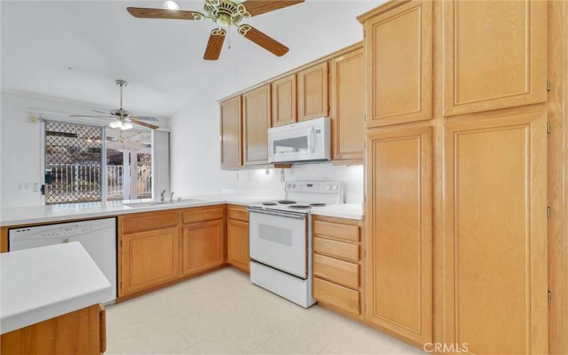 Kitchen with ceiling fans over this area and family dining area.