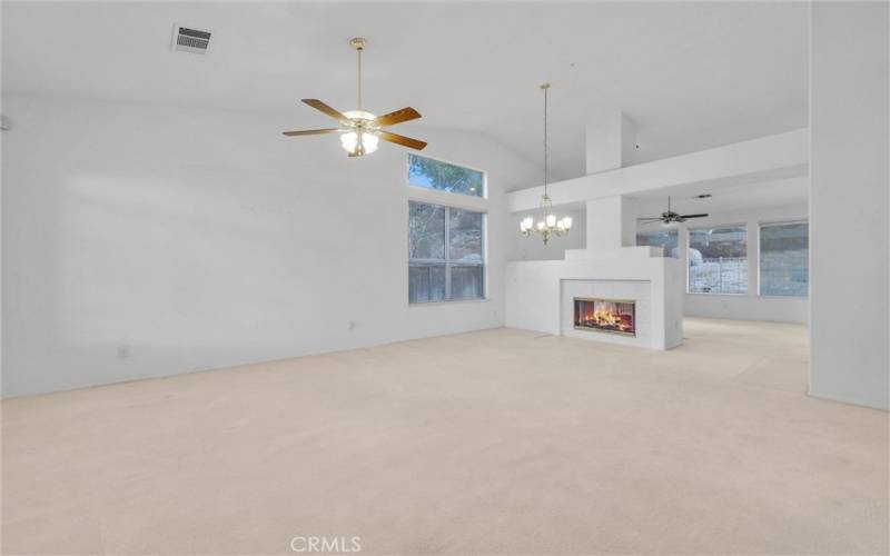 Living room with formal dining area near fireplace