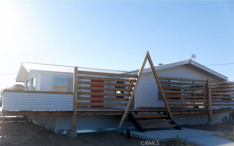 Western side of home featuring artistic privacy wall