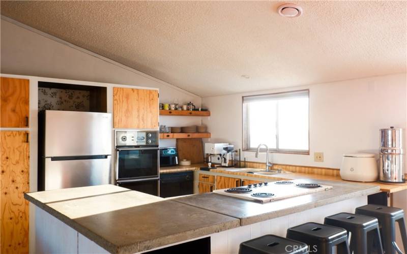 Open kitchen with custom concrete countertops