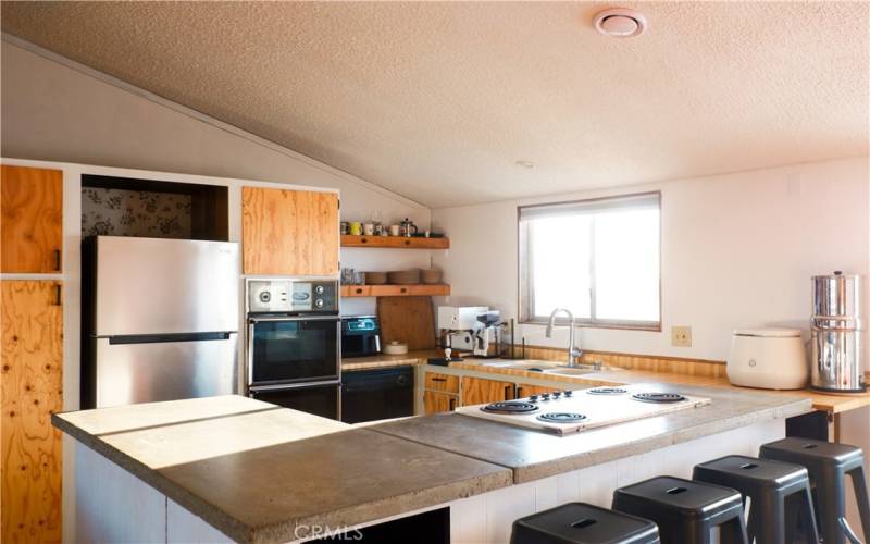 Open kitchen with custom concrete countertops