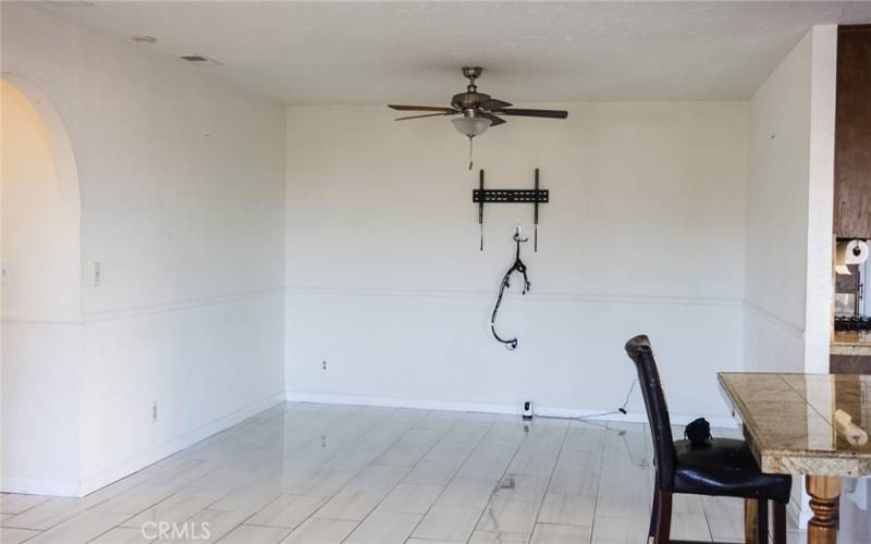 Formal dining area with ceiling fan and Tv moldings