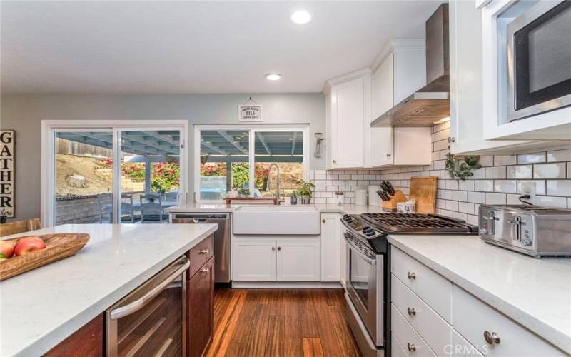 Kitchen with farmhouse sink, stainless-steel appliances and self-closing cabinet doors and drawers