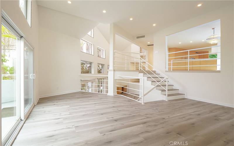 Living Room Leads to Lower Level Family Room and Patio