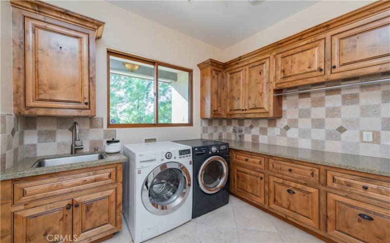 Large laundry room with wash sink and builtin iron board