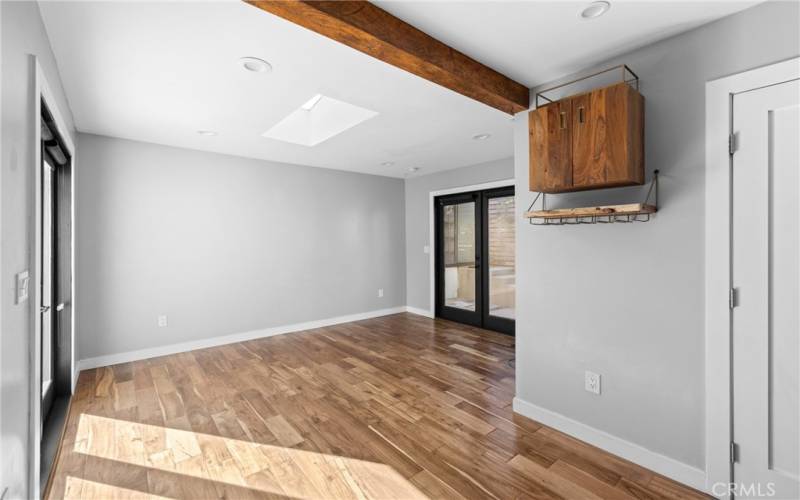 Living room with beamed ceilings, recessed lighting and even a nice wine cabinet/rack