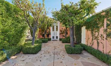 A private courtyard with lush greenery adds charm to the villa’s vibrant design.