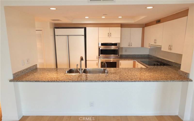 Updated kitchen cabinets accent the granite countertops.