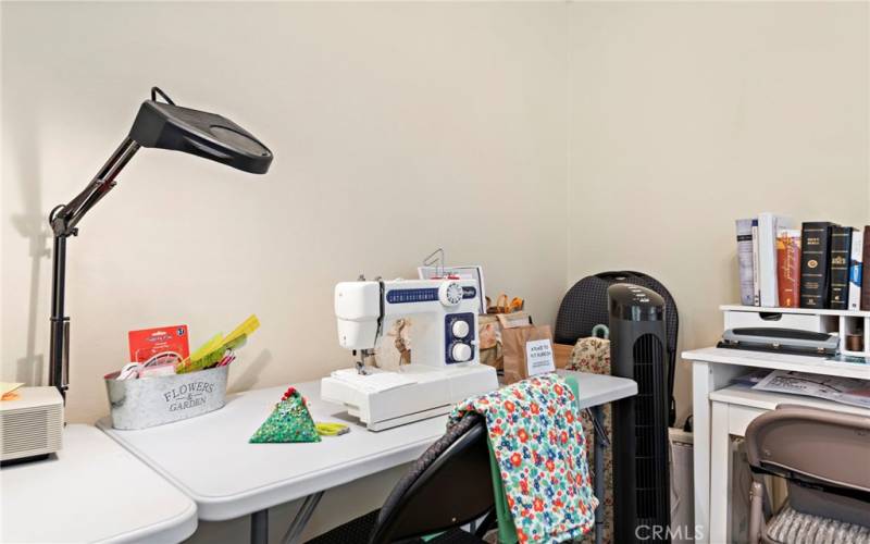 Craft space set up in the guest bedroom with ample natural light