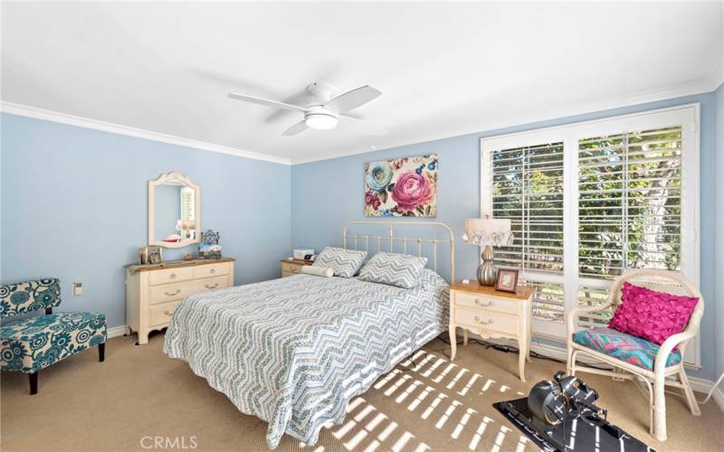 Light and bright primary bedroom with two window/slider exposures brings the feeling of privacy and the nature preserve to your home.