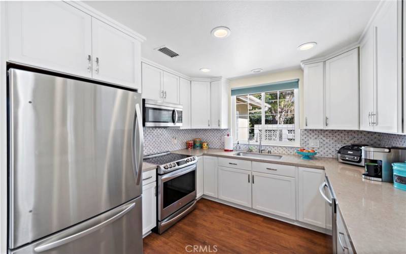 Stainless steel appliances and recessed lighting give this kitchen a modern classic and updated feel