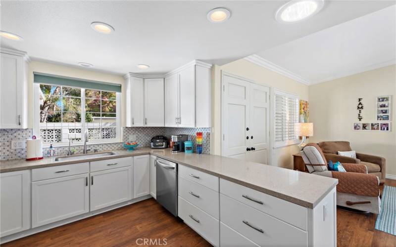 Fresh and bright kitchen with upgraded Diamond soft close cabinets, designer counters and tile backsplash.