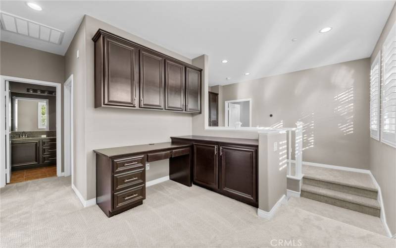 The is the dedicated home office area on the second level loft. It features a custom desk and cabinets that matches the rest of the home.