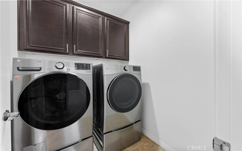 The laundry room includes the newer LG front-loading washer & dry with pedestal drawers plus upgraded cabinets!

