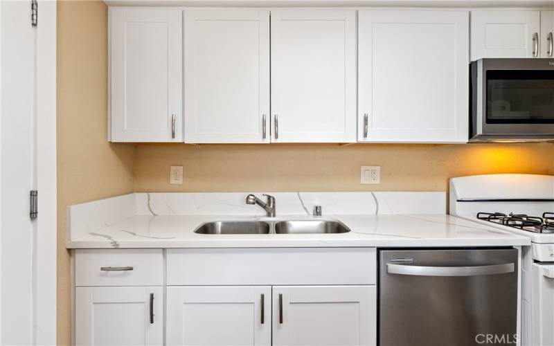 Super cool to have onsite laundry facilities! Through the kitchen door is access to the deep, single-car garage where there are hookups for a washer/dryer!